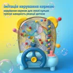 Інфографіка дитячого автомата Ловець м'ячів українською мовою: опис функції імітації керування кермом для ловлі кульок, що тренує швидкість реакції дитини